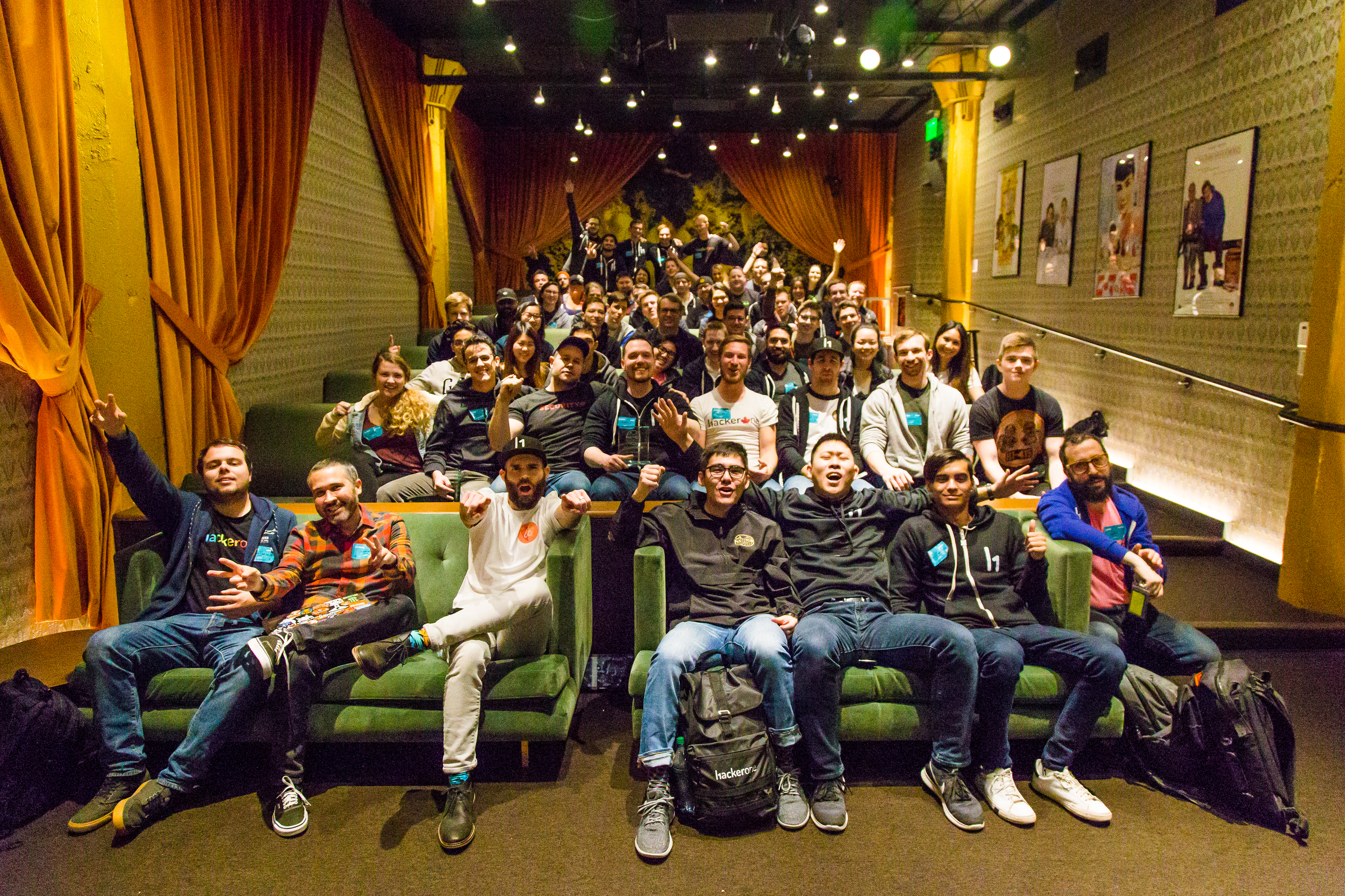 Attendees pose for a photo in Airbnb’s amazing theatre at the end of day 1 of h1-415