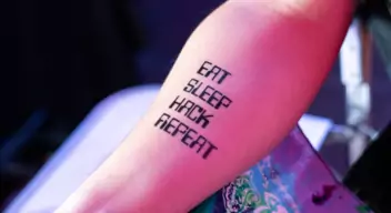 A tattoo on an ethical hacker that reads "Eat, Sleep, Hack, Repeat"