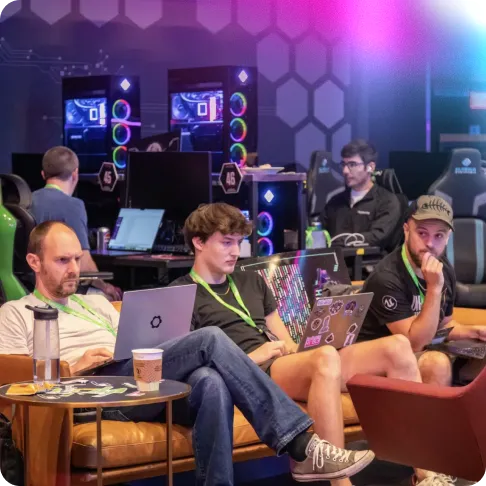 Researchers sitting on a couch looking at their laptop